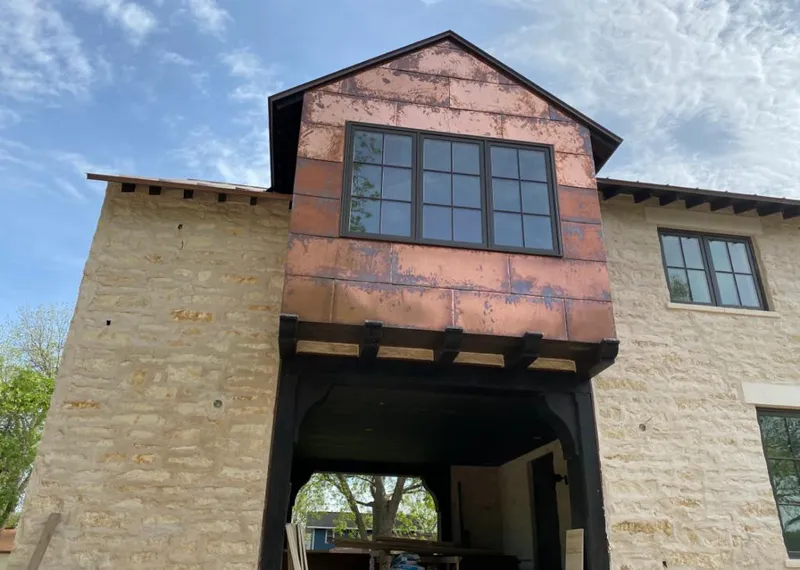 Copper metal panel facade on a stone building for Skylight Installation in Beaver Dam